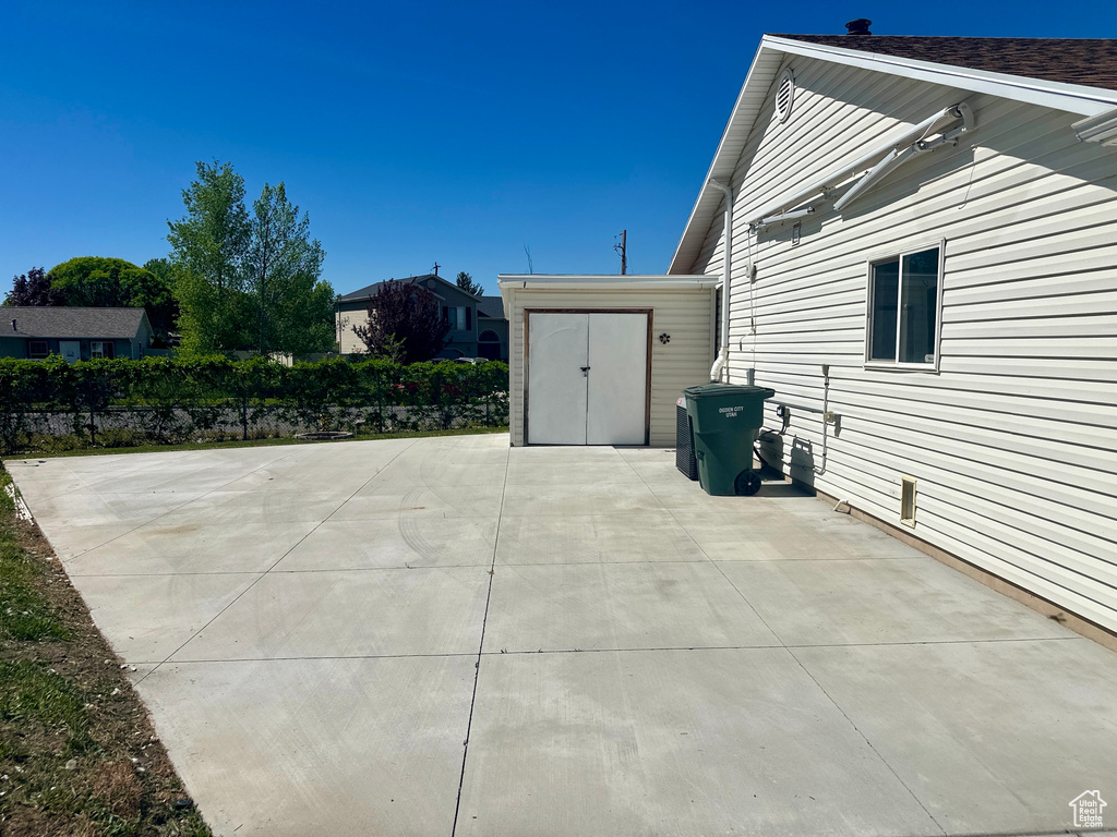 View of patio featuring a storage shed and an outdoor structure