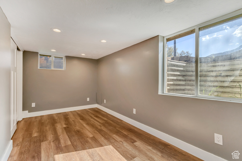 Basement with recessed lighting, baseboards, and wood finished floors