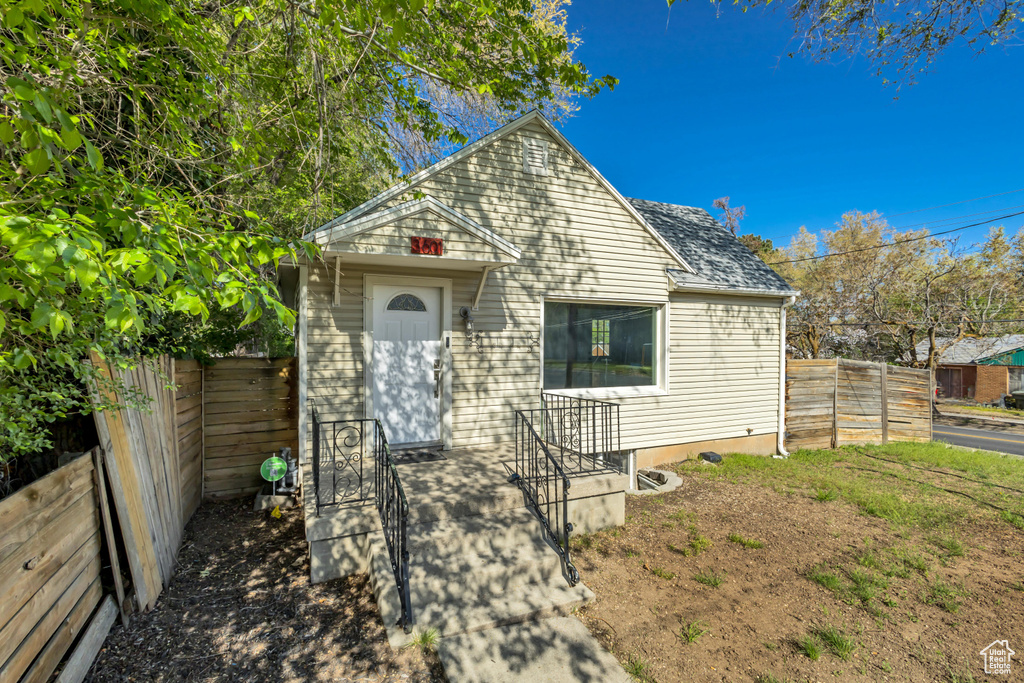 View of front of property featuring fence