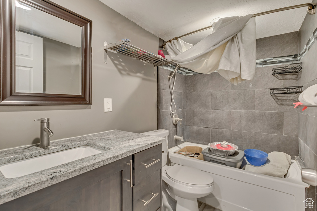 Bathroom featuring vanity, shower / bathing tub combination, and toilet