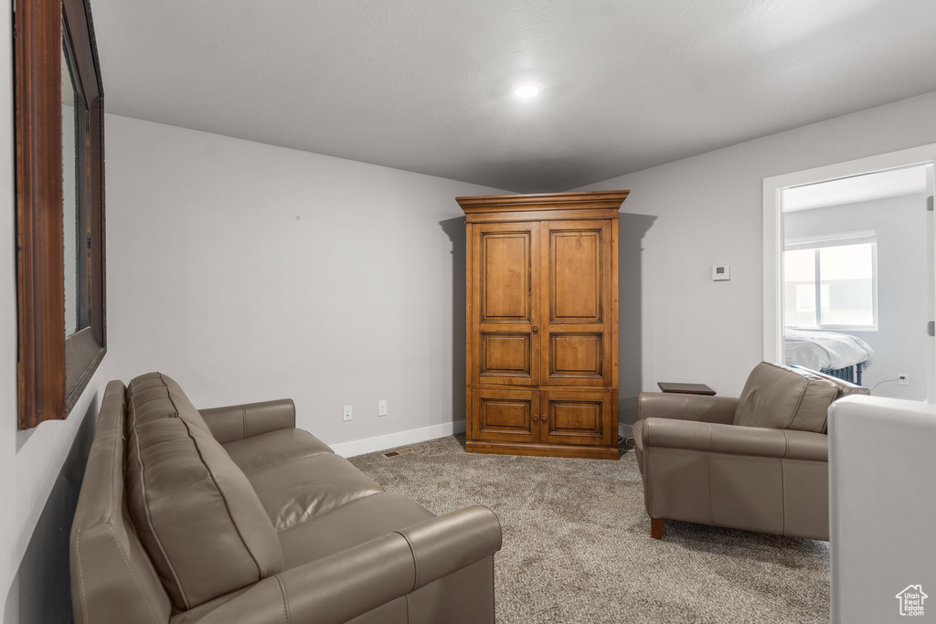 Carpeted living area featuring baseboards