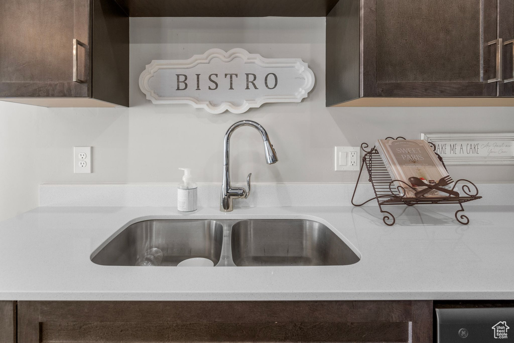 Interior details featuring light countertops, dark brown cabinetry, and a sink