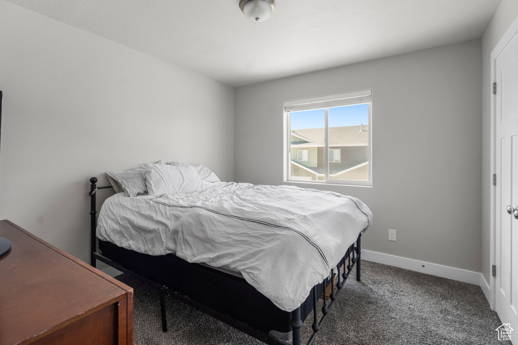 Bedroom with baseboards and carpet flooring