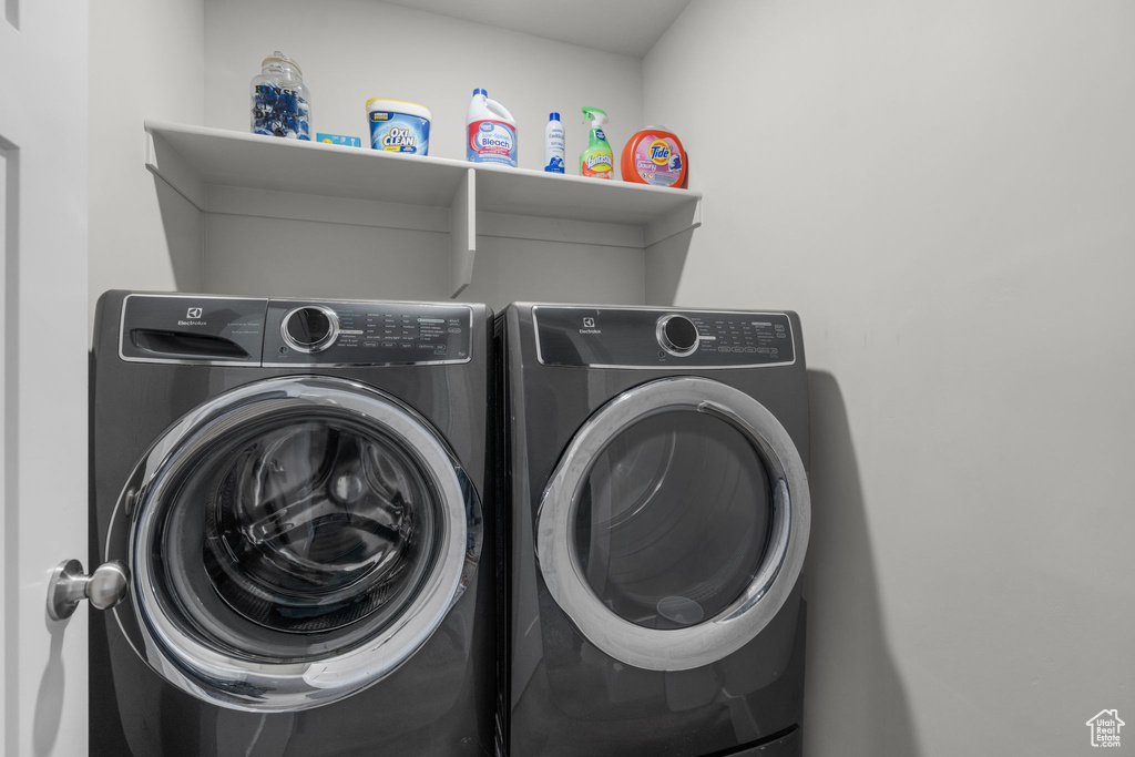 Clothes washing area featuring laundry area and separate washer and dryer
