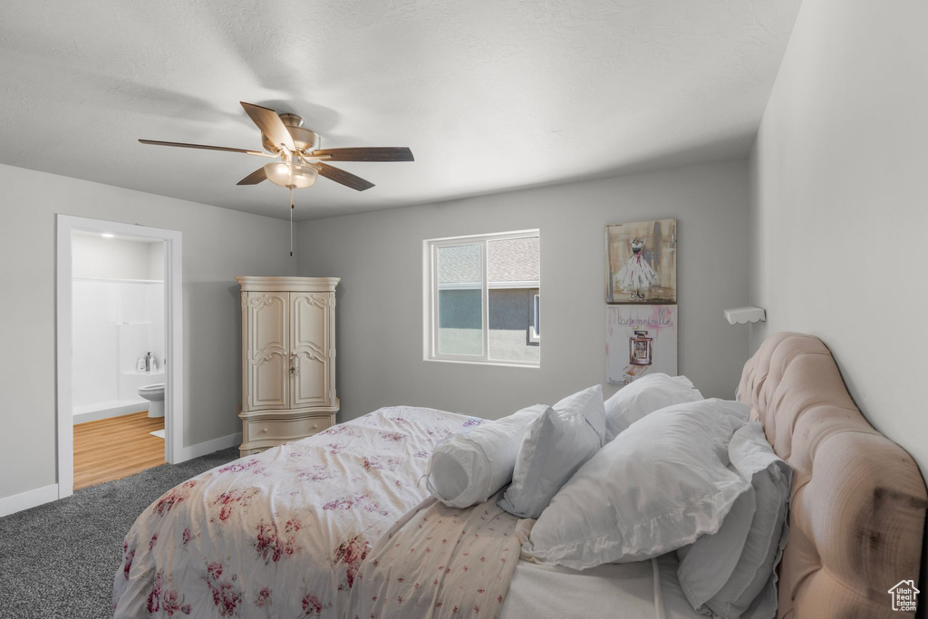 Bedroom with ceiling fan, baseboards, carpet, and ensuite bath