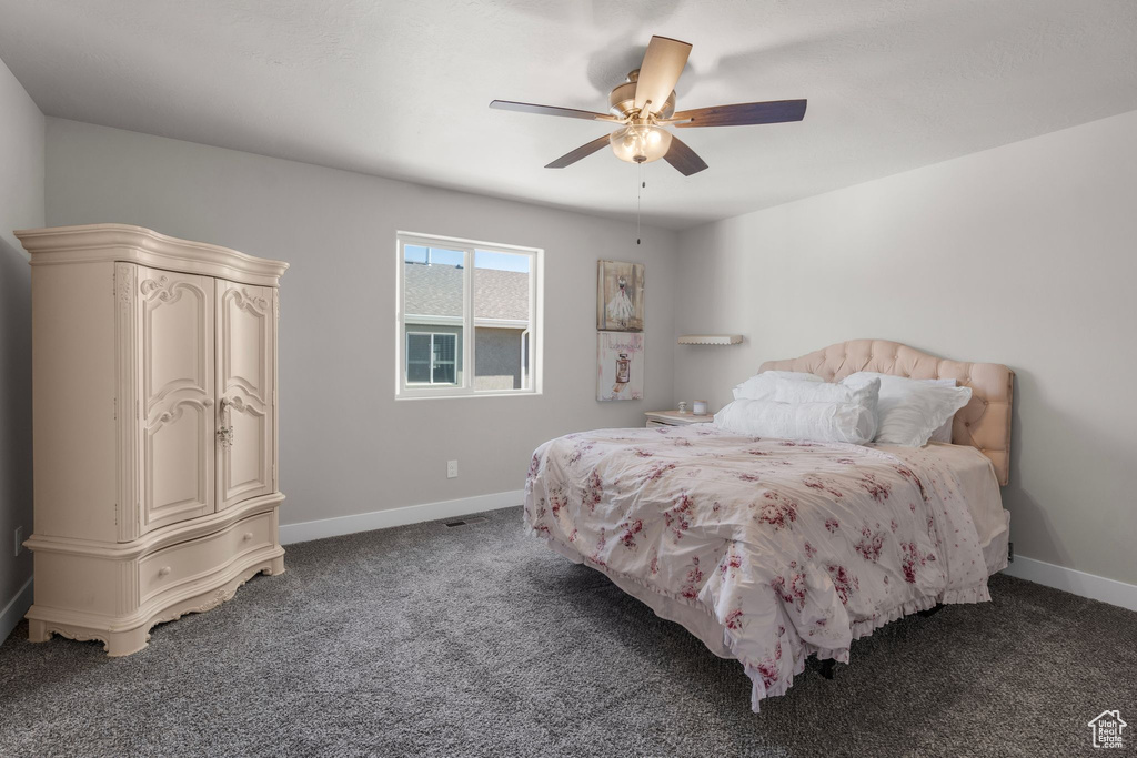 Bedroom with baseboards, ceiling fan, and carpet