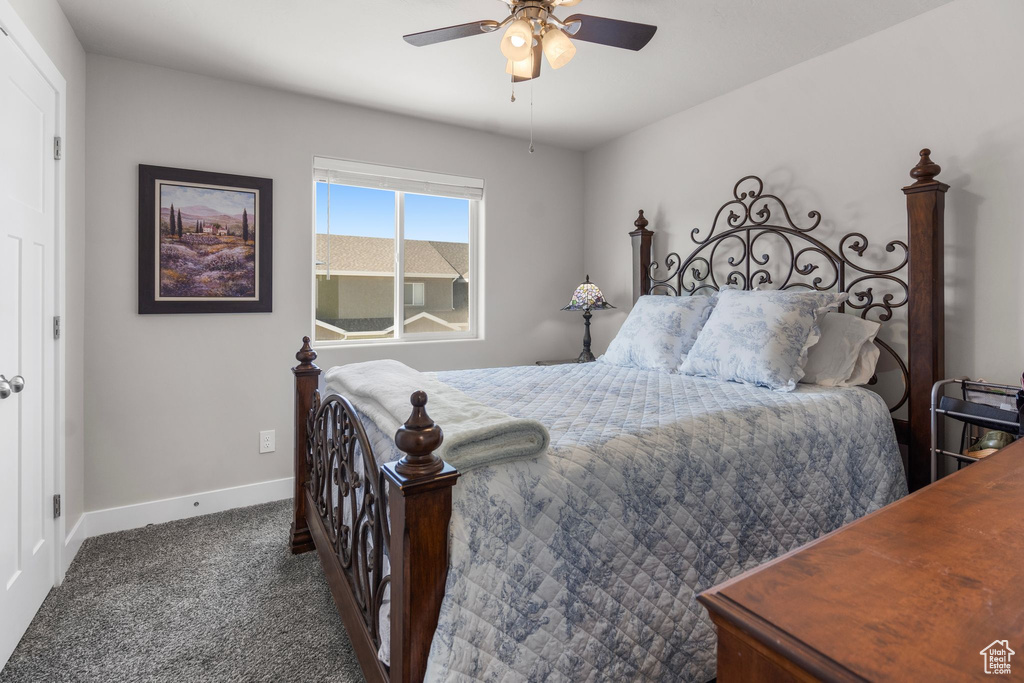 Bedroom featuring baseboards, ceiling fan, and carpet flooring
