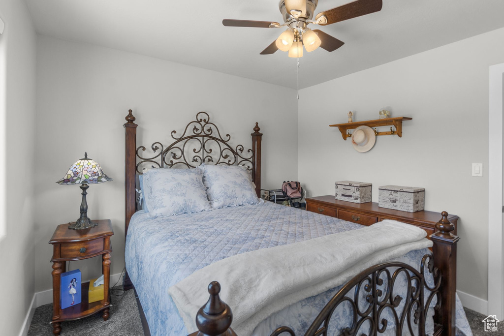 Carpeted bedroom with baseboards and ceiling fan