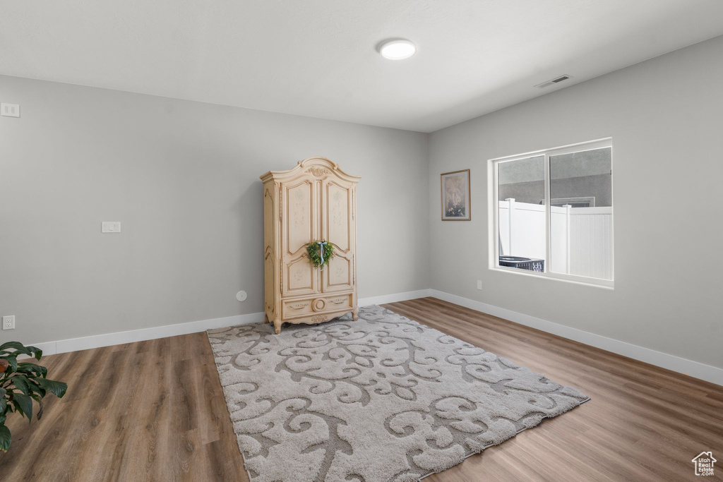 Unfurnished room featuring light wood-style floors, baseboards, and visible vents