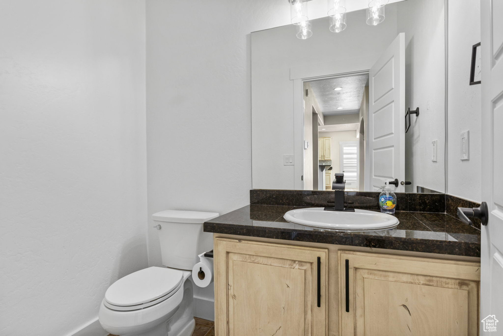Bathroom featuring vanity and toilet