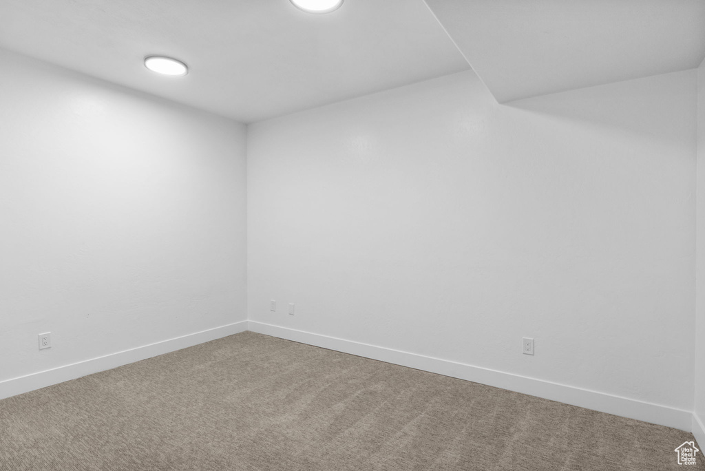 Carpeted spare room with baseboards