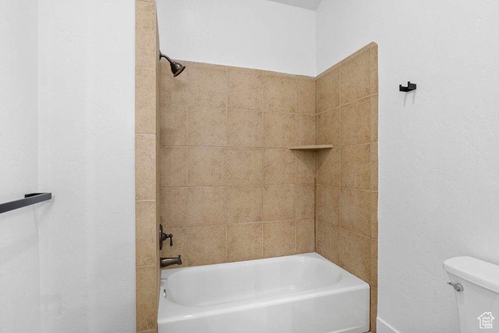 Bathroom featuring toilet and tub / shower combination