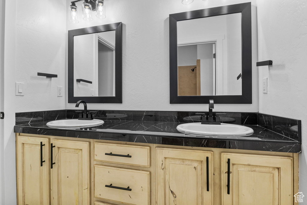 Full bathroom featuring double vanity and a sink