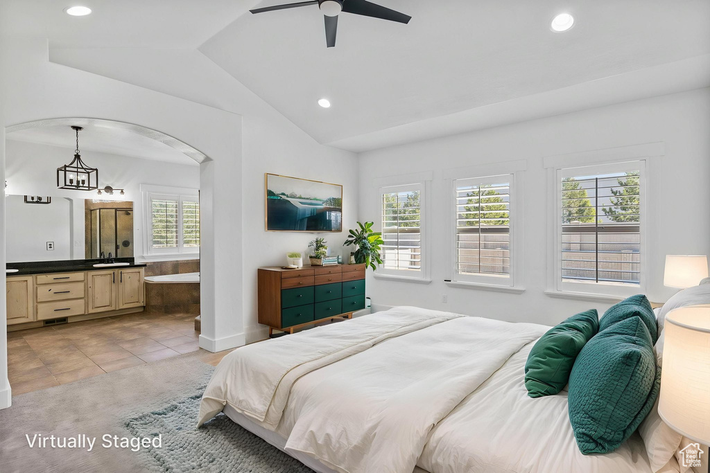 Bedroom featuring light tile patterned floors, multiple windows, recessed lighting, and lofted ceiling