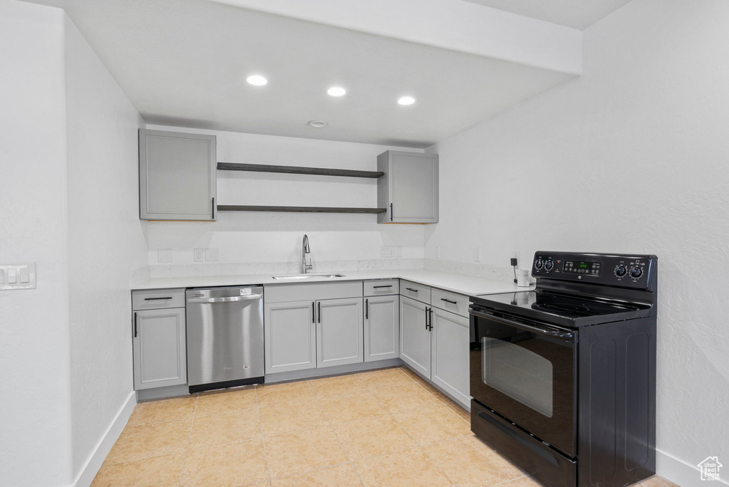 Kitchen with open shelves, gray cabinets, dishwasher, and black range with electric stovetop
