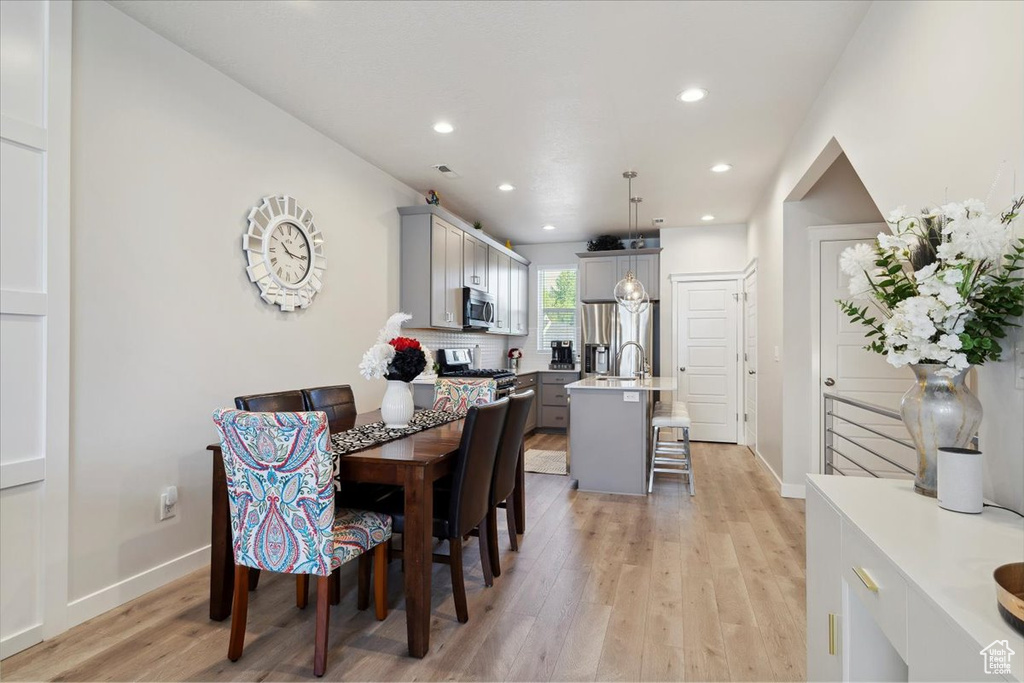 Dining space featuring light wood-type flooring, recessed lighting, and baseboards