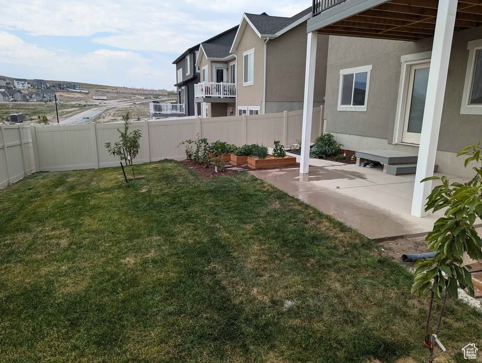 View of yard featuring a patio and a fenced backyard