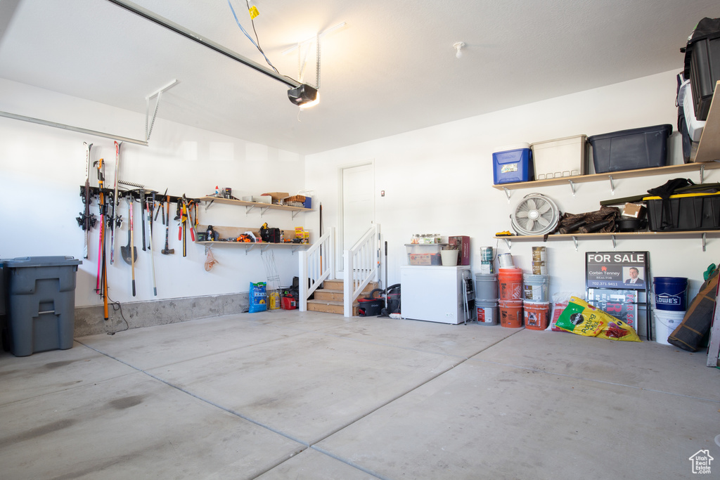 Garage featuring a garage door opener