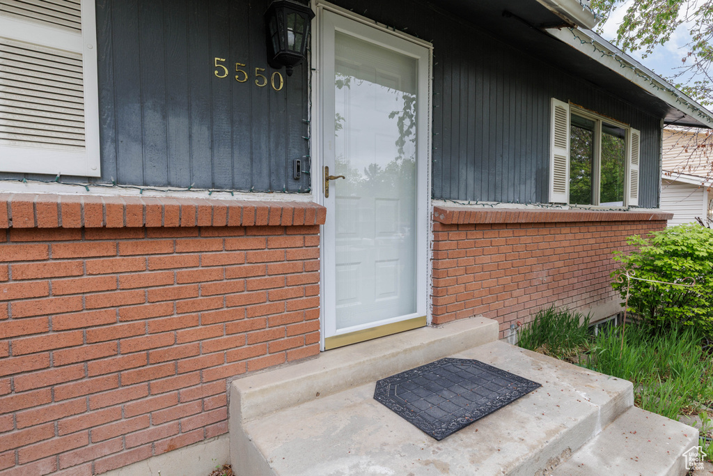 Property entrance featuring brick siding