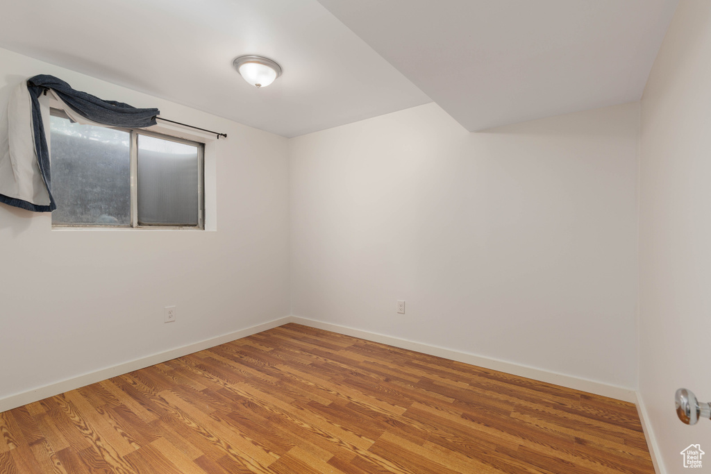 Empty room featuring baseboards and light wood finished floors