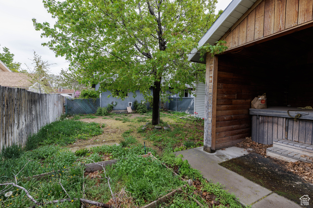 View of yard featuring a fenced backyard and a garden