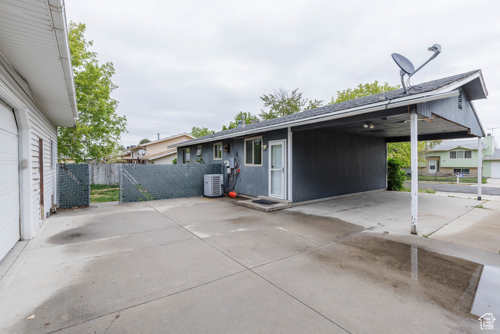 View of home\'s exterior featuring fence, driveway, a patio area, and a carport