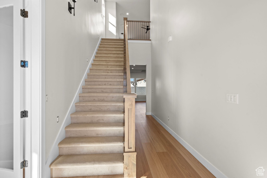 Stairs with baseboards and wood finished floors