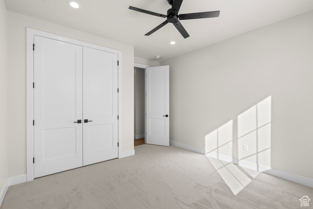 Unfurnished bedroom with recessed lighting, carpet, baseboards, and a closet