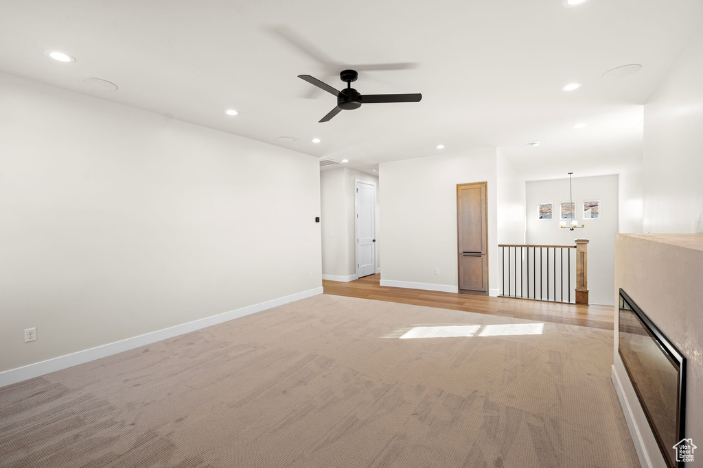 Unfurnished room featuring baseboards, ceiling fan, recessed lighting, and light wood-style flooring