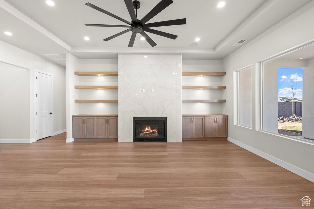 Unfurnished living room with baseboards, light wood-type flooring, a ceiling fan, and recessed lighting