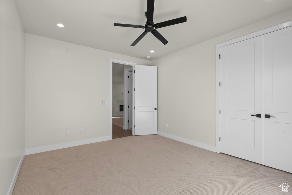Unfurnished bedroom with carpet flooring, recessed lighting, and baseboards