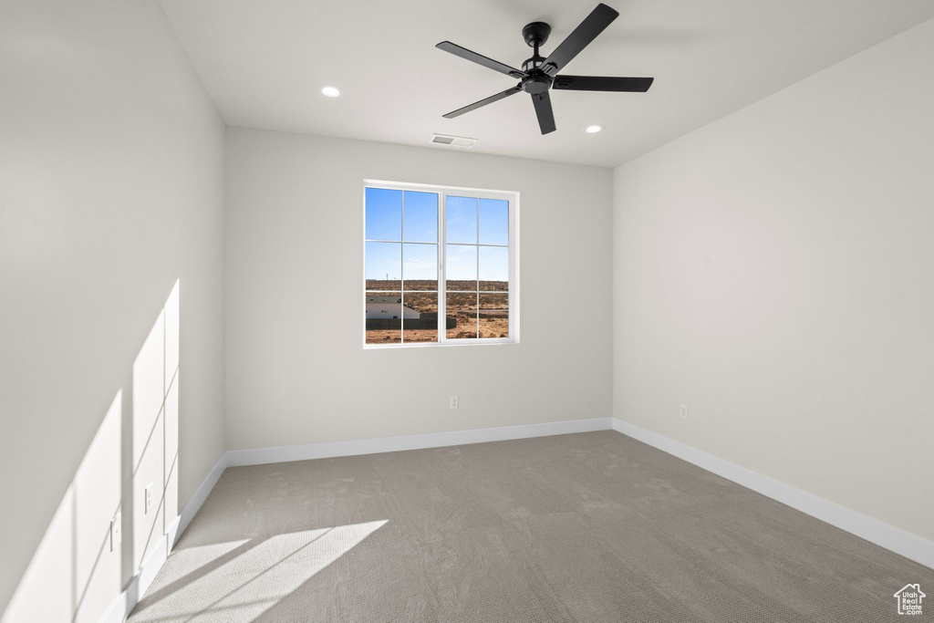 Carpeted empty room with visible vents, recessed lighting, baseboards, and a ceiling fan