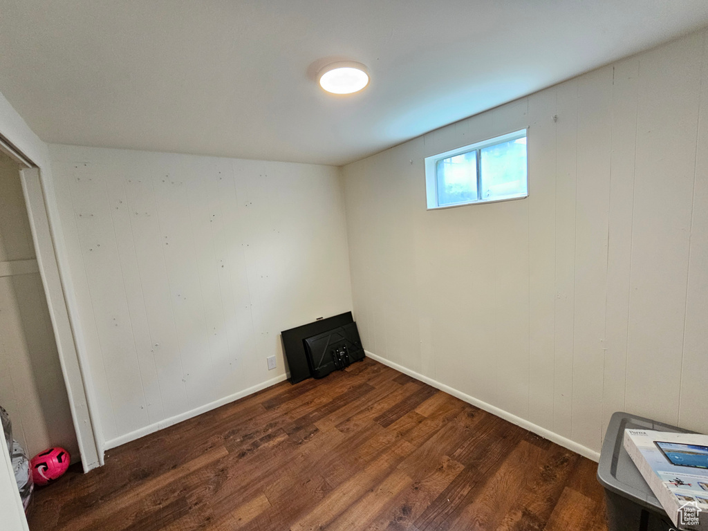Basement featuring baseboards and wood finished floors
