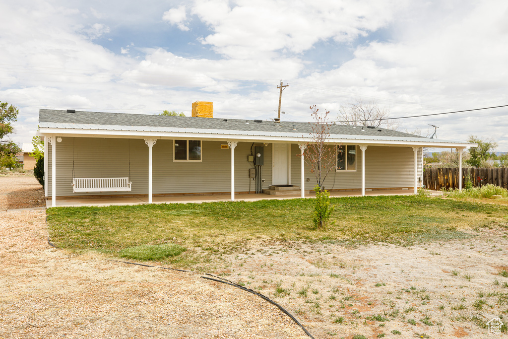 Rear view of property with fence, a patio, and a chimney