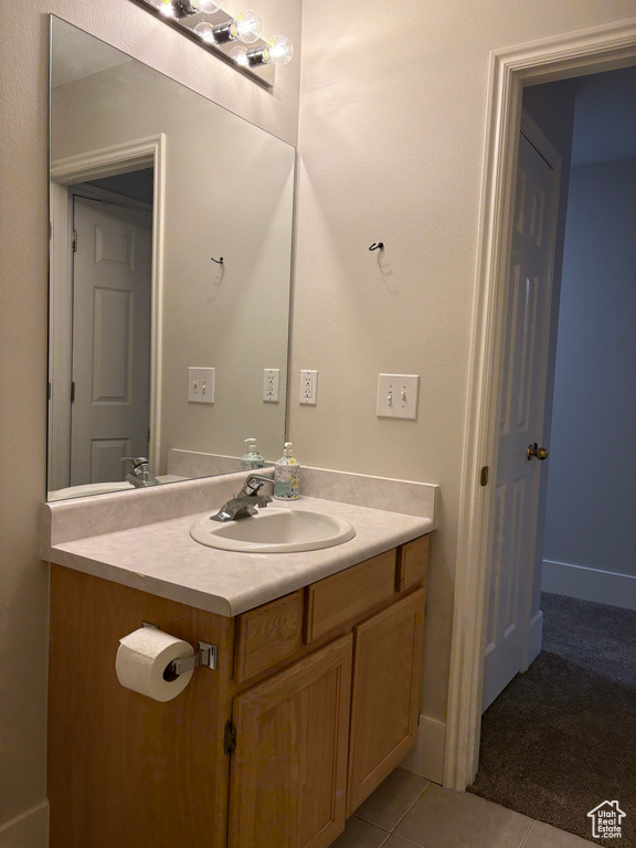 Bathroom with tile patterned flooring and vanity
