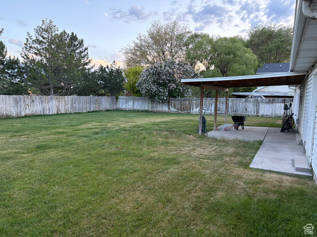 View of yard featuring a fenced backyard and a patio area