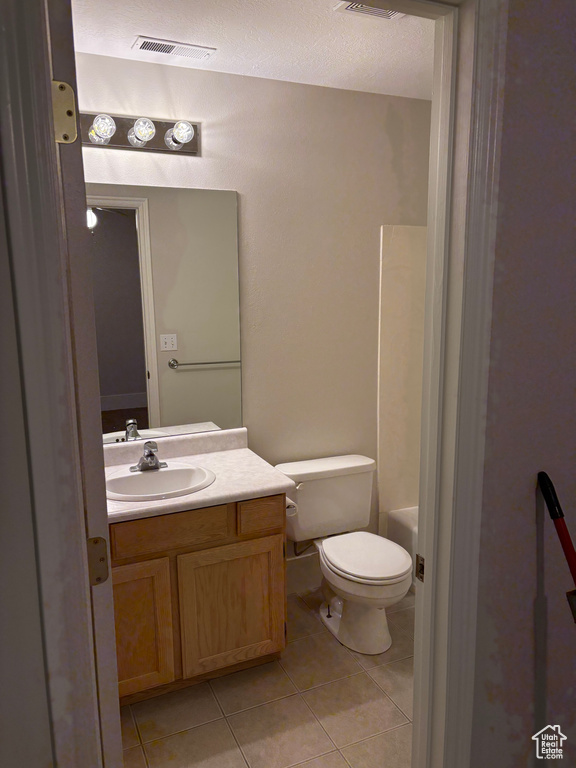 Bathroom with tile patterned flooring, visible vents, toilet, and vanity