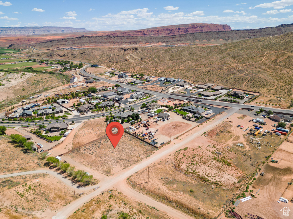 Birds eye view of property with view of desert and a mountain view