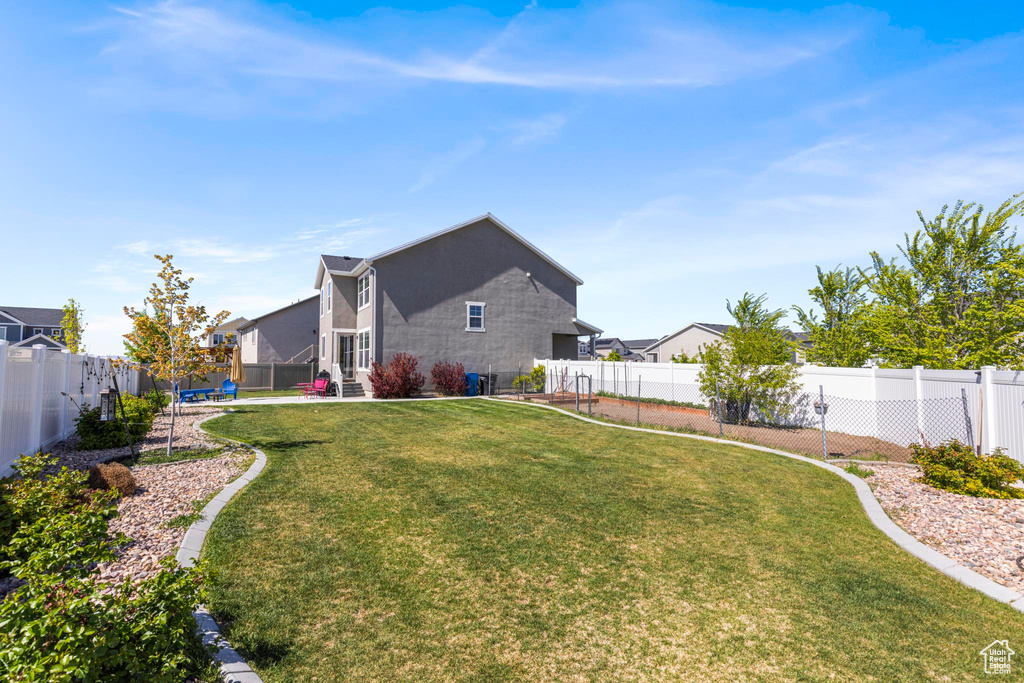 View of yard featuring a fenced backyard and a patio