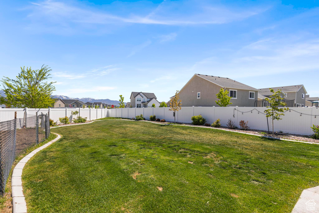 View of yard with a fenced backyard and a residential view