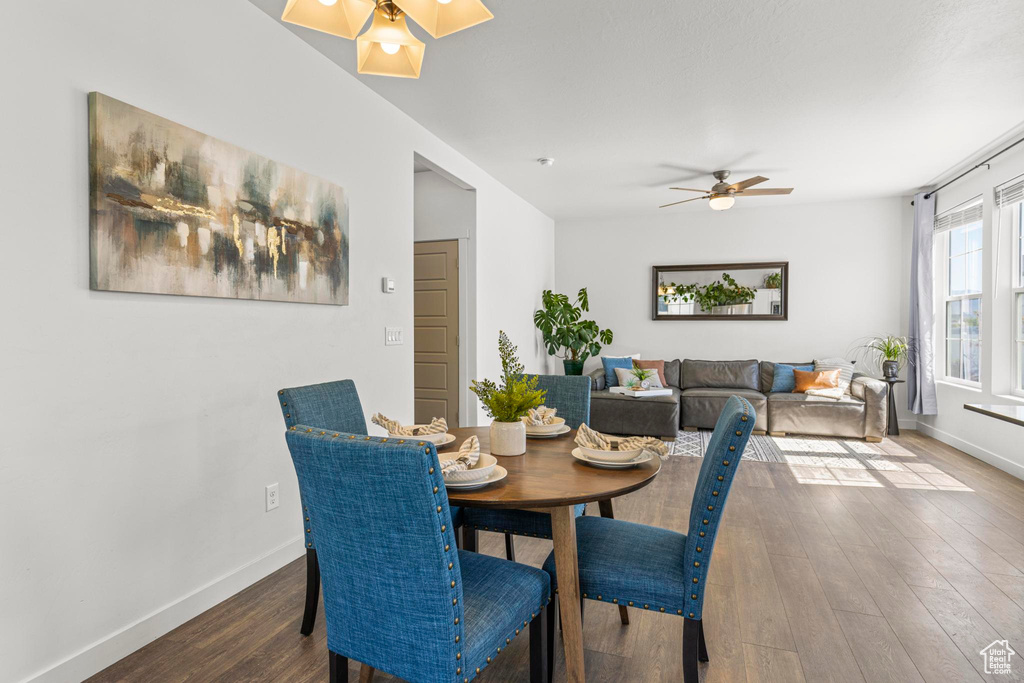 Dining room featuring baseboards, a ceiling fan, and wood finished floors