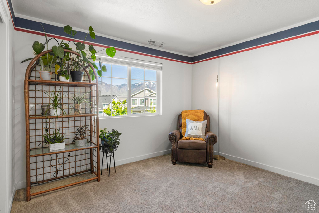 Sitting room with carpet flooring, baseboards, and visible vents