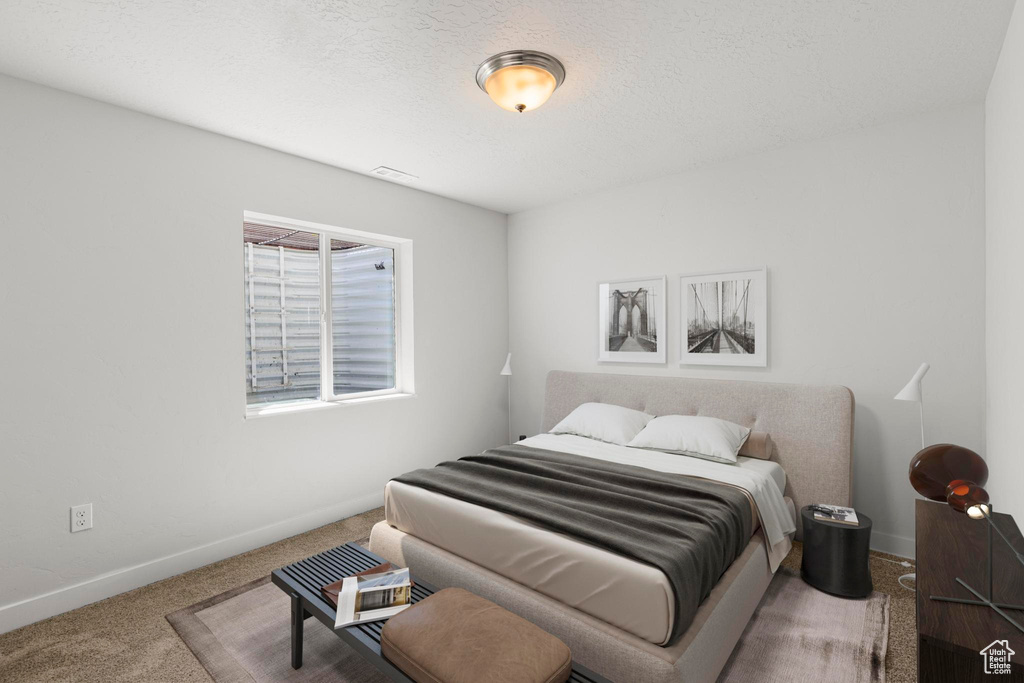 Bedroom with carpet floors, baseboards, and visible vents