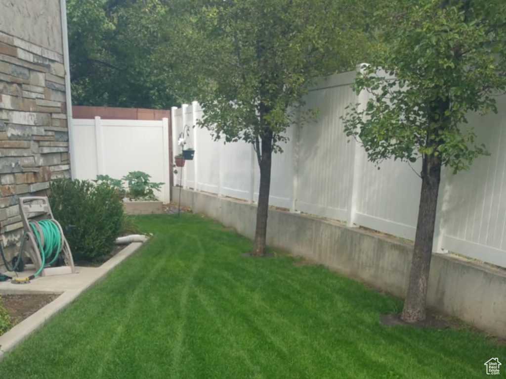 View of yard featuring fence
