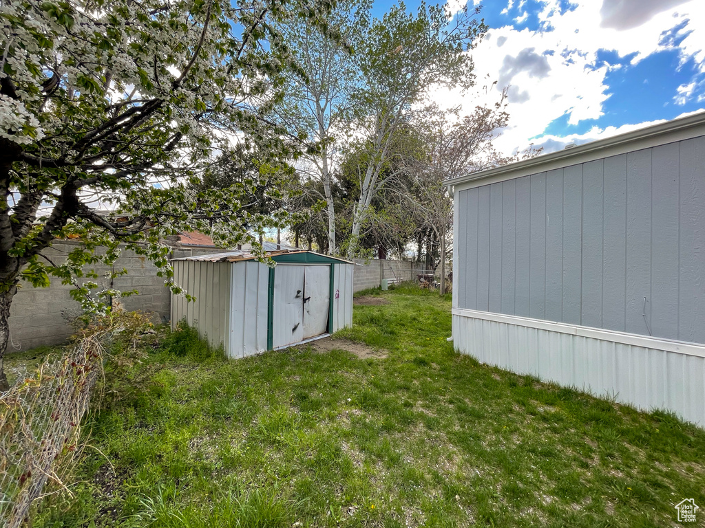 View of yard with a storage unit and an outdoor structure