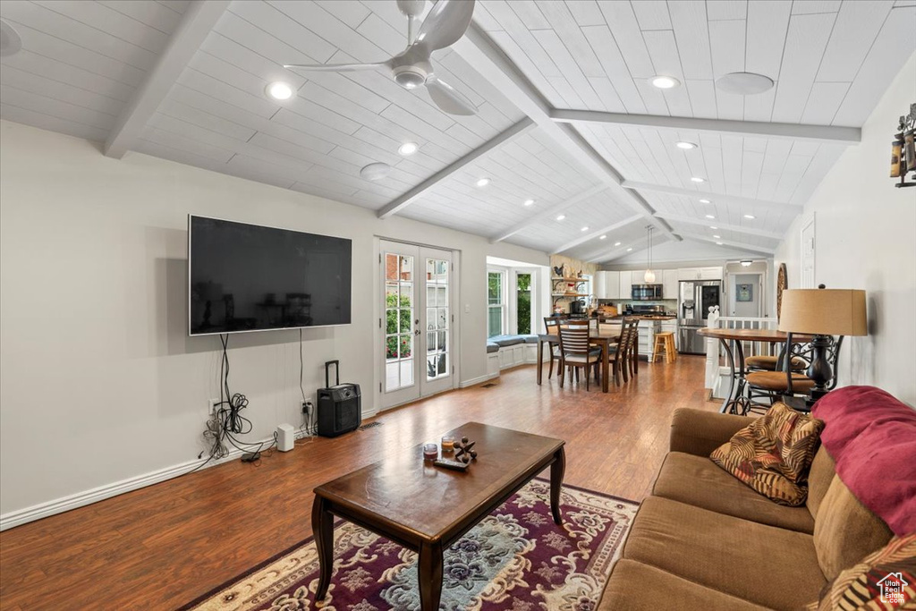 Living area featuring light wood finished floors, ceiling fan, recessed lighting, french doors, and wood ceiling