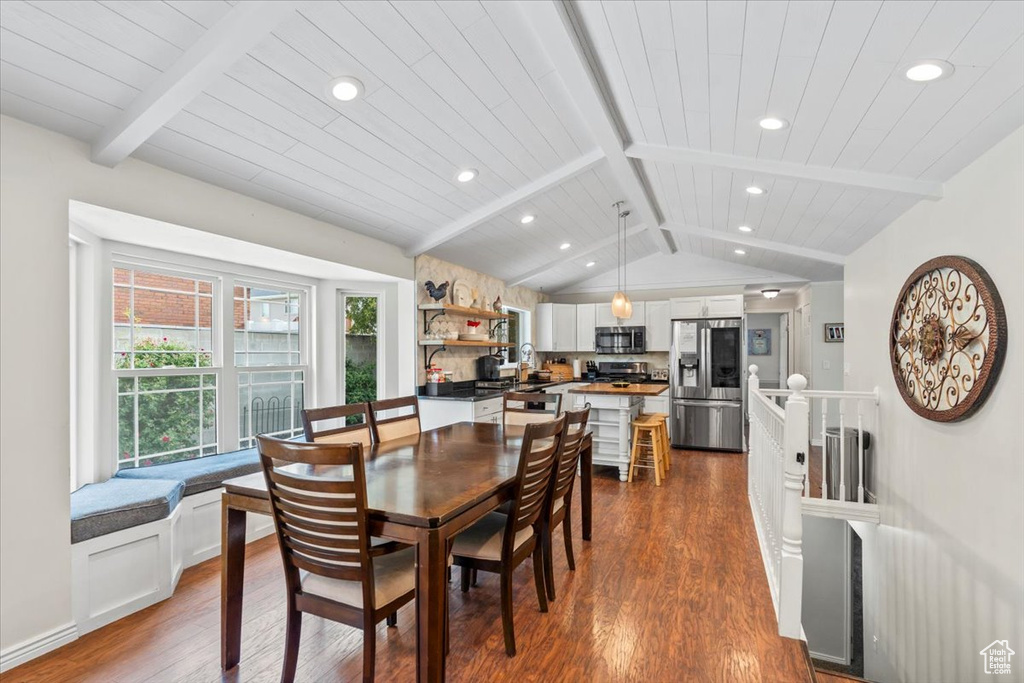 Dining space with dark wood finished floors, recessed lighting, and wood ceiling