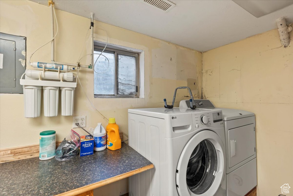 Laundry area with washing machine and clothes dryer and electric panel