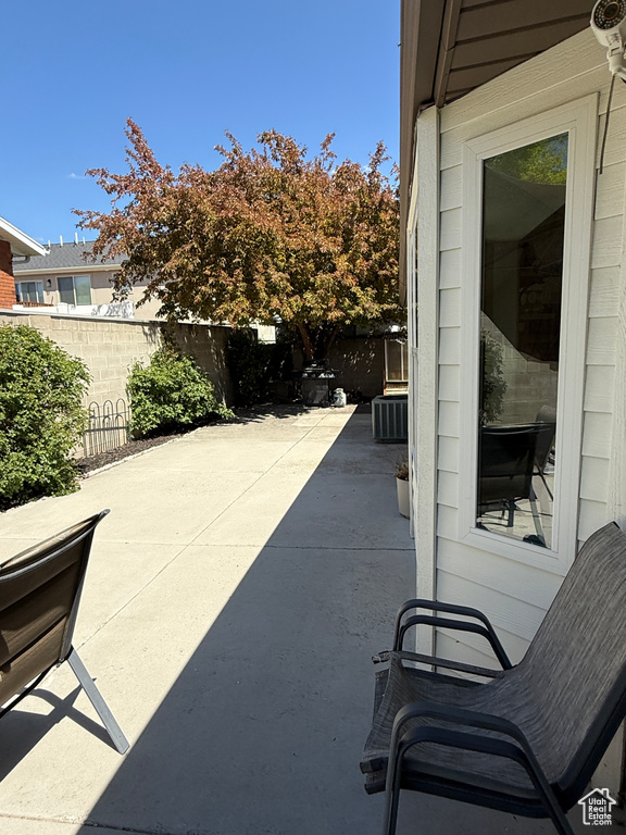 View of patio featuring a fenced backyard and central AC unit