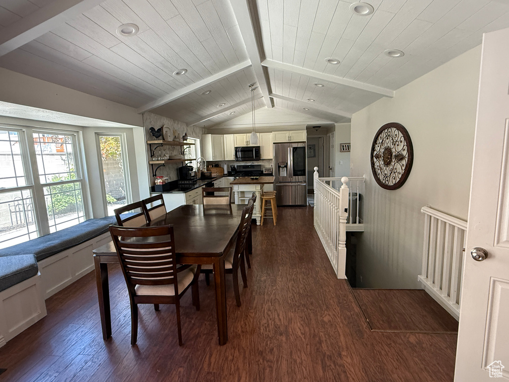 Dining room with recessed lighting, dark wood finished floors, vaulted ceiling with beams, and wood ceiling